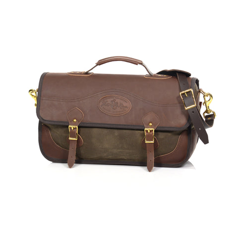 Brief bag made with premium leather, waxed canvas, and solid brass attachments.