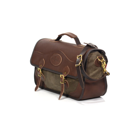 Leather and waxed canvas brief bag with a leather shoulder strap and pad.