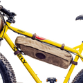This bike bag connects to the inside of the bike frame with four adjustable leather straps connected to solid brass posts.